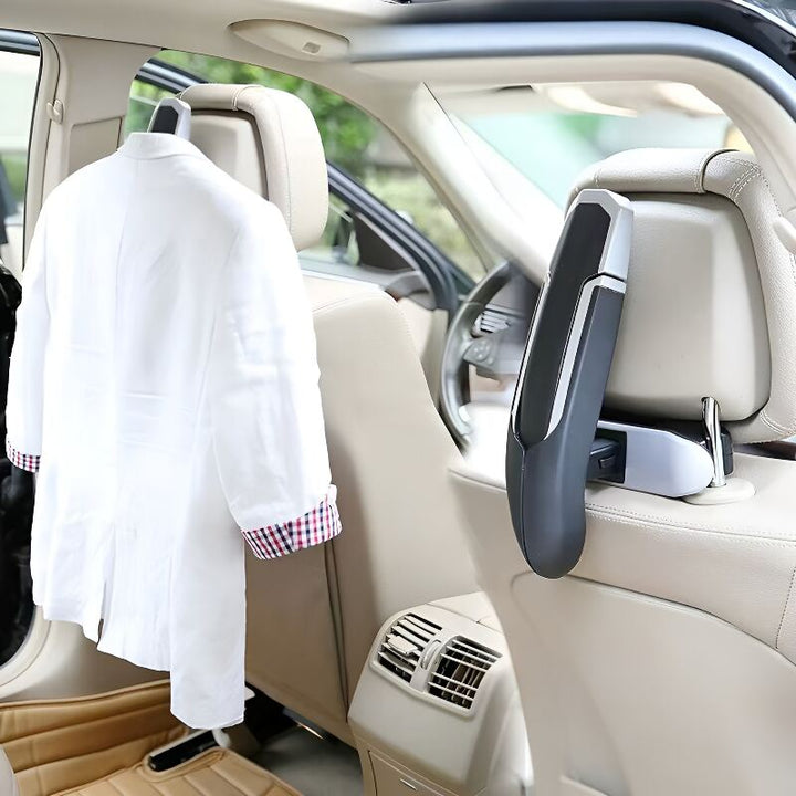 Car headrest hanger holding clothes in vehicle