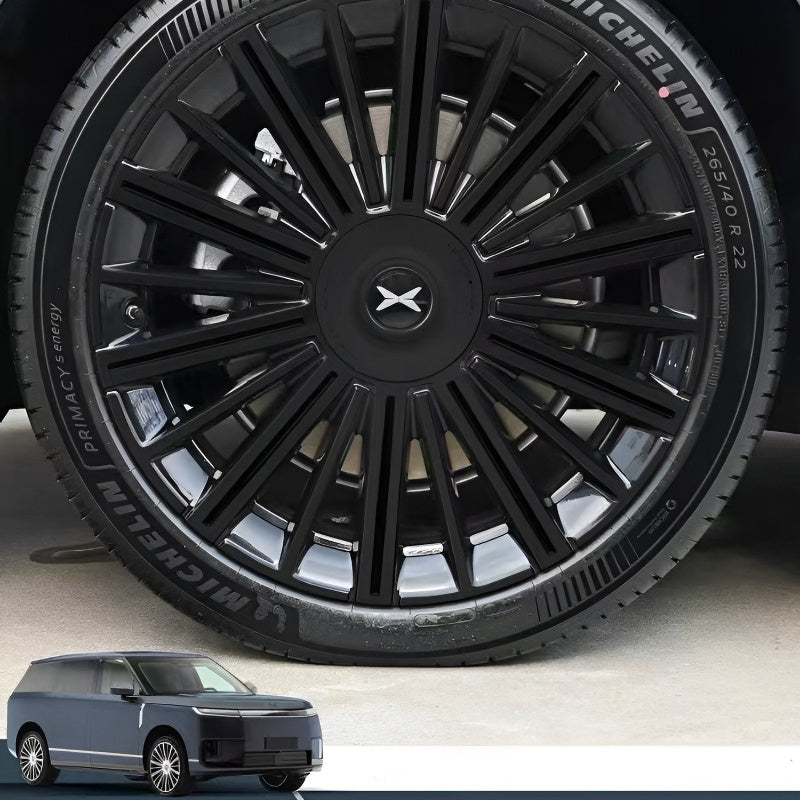 Close‑up of XPENG GX wheel hubcap covered with blackout PVC stickers