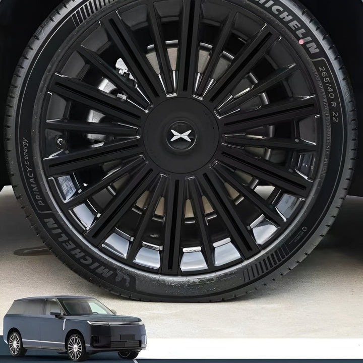 Close‑up of XPENG GX wheel hubcap covered with blackout PVC stickers